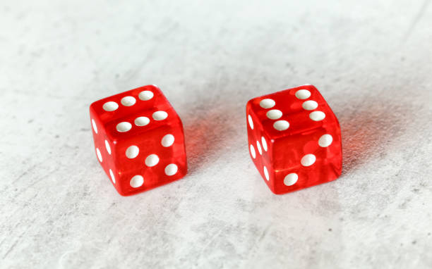 istock Two translucent red craps dices on white board showing Boxcars or Midnight (double number 6) 1167944491