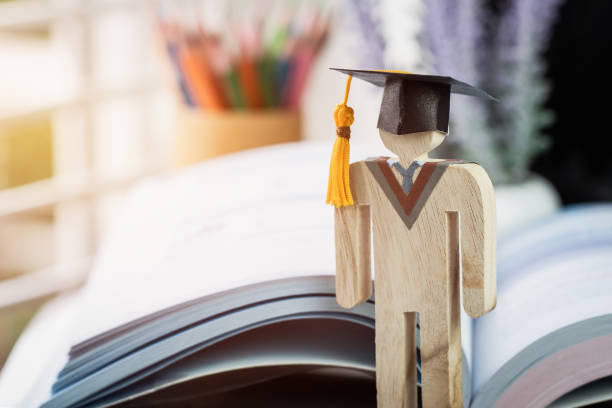 istock Education knowledge learning study abroad international Ideas. People Sign wood Graduation celebrating cap on textbook in library,Alternative studying distant for learn.Back to School in successful 1167946500