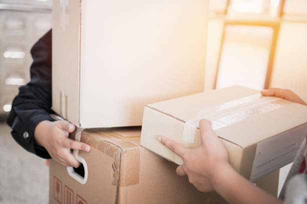 istock Deliveryman get parcel box package to Asian Customer accepting delivery of boxes packages from deliver, Online shopping shipping, ecommerce delivery service concept 1167946515