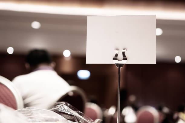 istock Mock up white Label for blank menu frame in seminar room or conference hall light on desk groups for letter, Event Background. Business Talk Presentation. 1167946568
