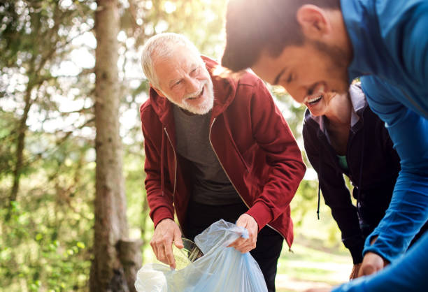 istock Group of active people picking up litter in nature, a plogging concept. 1167949865