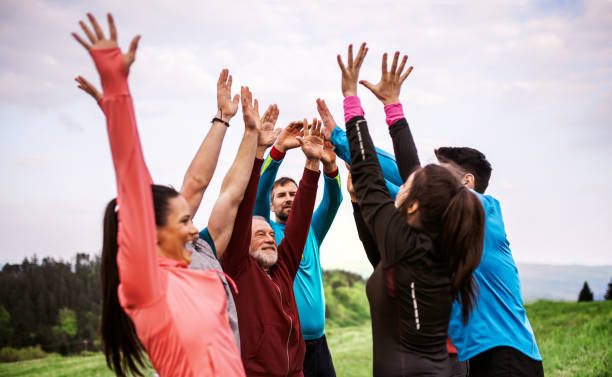 istock Large group of fit and active people resting after doing exercise in nature. 1167949949