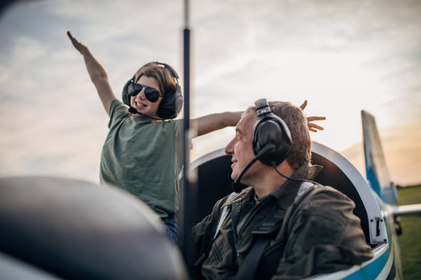 istock Daughter and father pilot sitting in airplane 1167949971