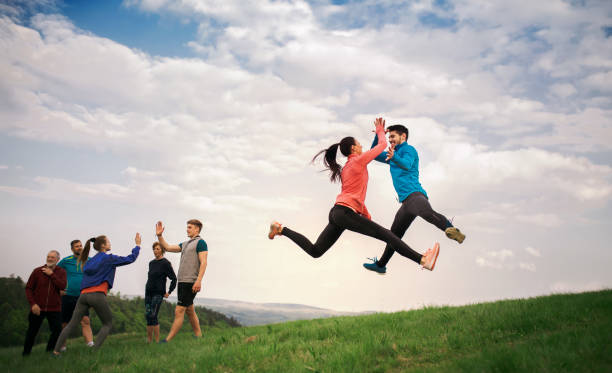 istock Large group of fit and active people jumping after doing exercise in nature. 1167949972
