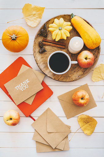 Thanksgiving still life flat lay with pumpkins, coffee and envelopes