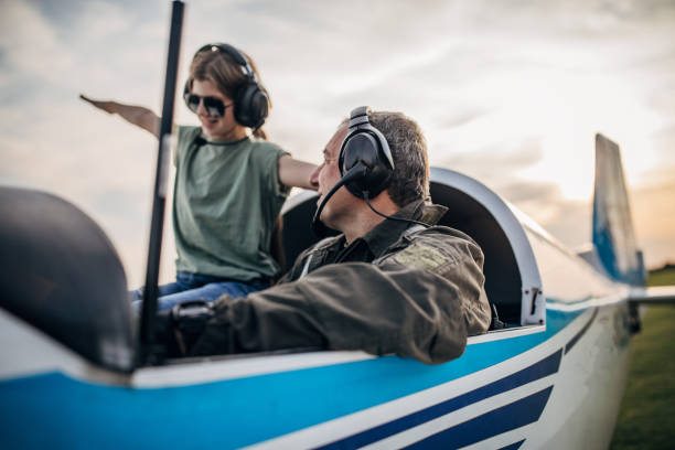 istock Daughter and father pilot sitting in airplane 1167950221