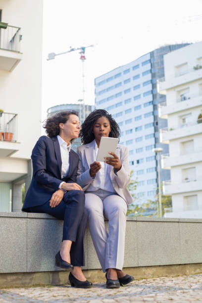 istock Multiethnic businesswomen with tablet computer outdoor 1167951898