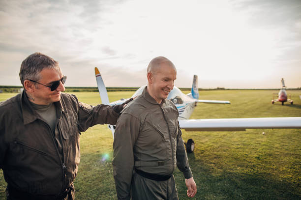 istock Two pilots standing by the propeller airplane 1167952540