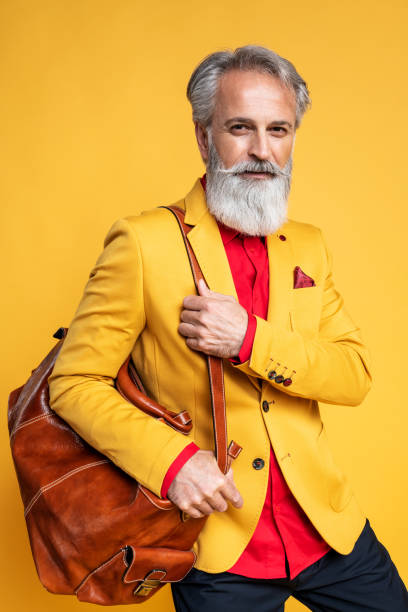 istock Happy well dressed gentleman having photoshooting in studio 1167958485