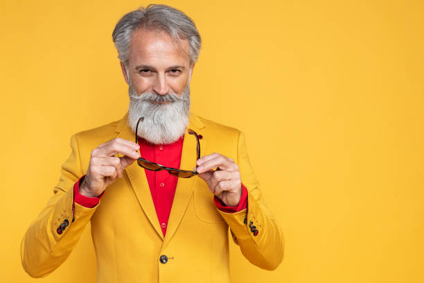 istock Happy well dressed gentleman having photoshooting in studio 1167958746
