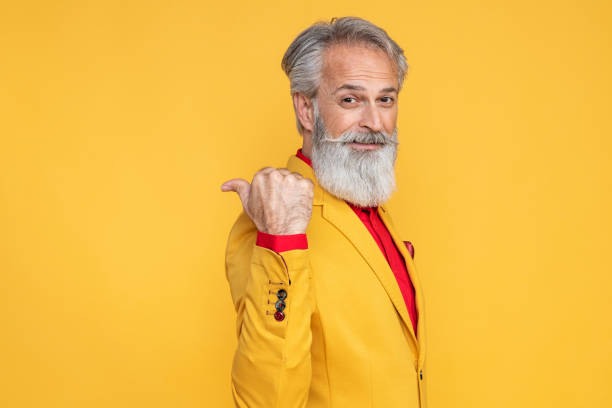 Happy well dressed gentleman having photoshooting in studio