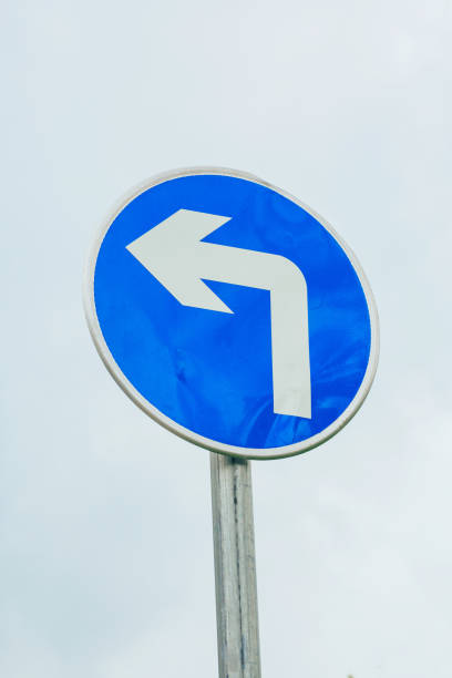 istock Blue white traffic symbol logo with sky and turn 1167958849