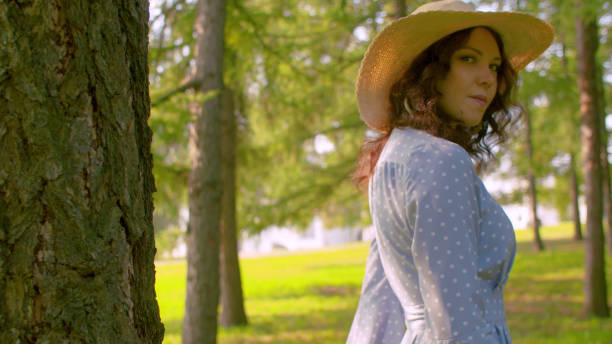 istock Young attractive woman standing near the tree 1167961556