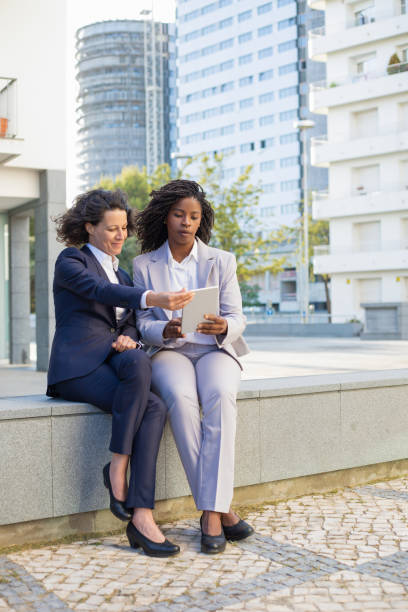 istock Professional female colleagues with digital tablet 1167963240