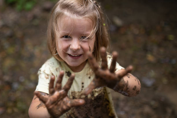 istock Smiling girl playing in forest 1167963575