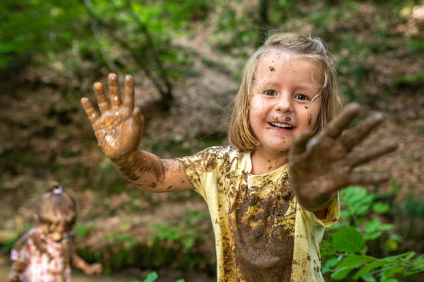 Smiling girl playing in forest stock photo