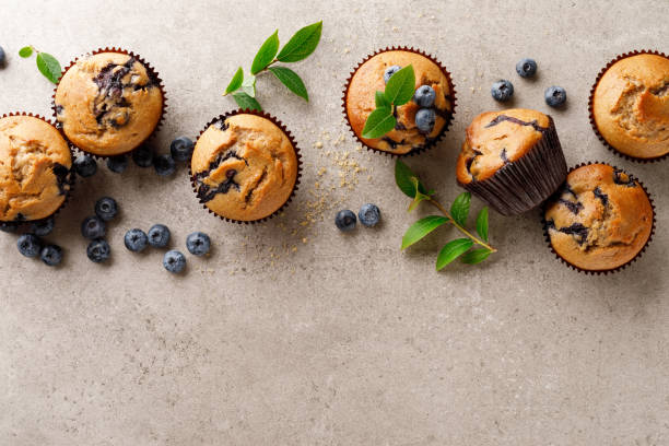 istock Blueberry muffins with fresh berries, top view 1167964792