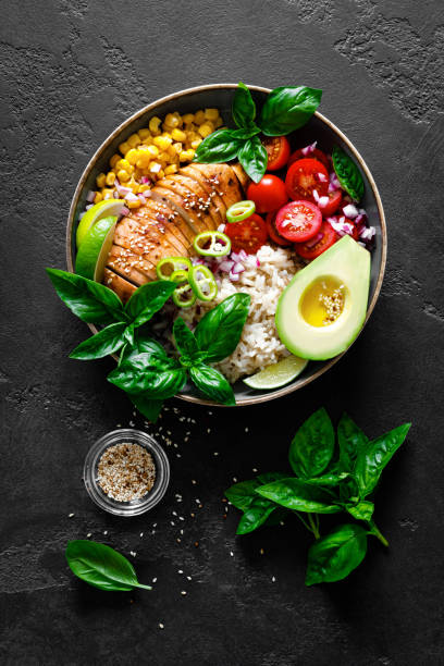 istock Grilled chicken breast lunch bowl with fresh tomato, avocado, corn, red onion, rice and basil 1167965359