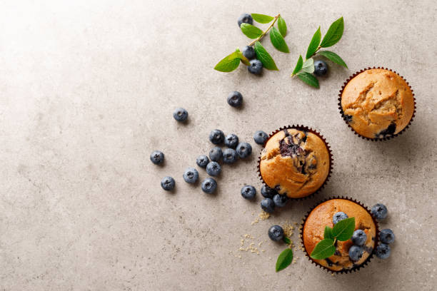 istock Blueberry muffins with fresh berries, top view 1167965412