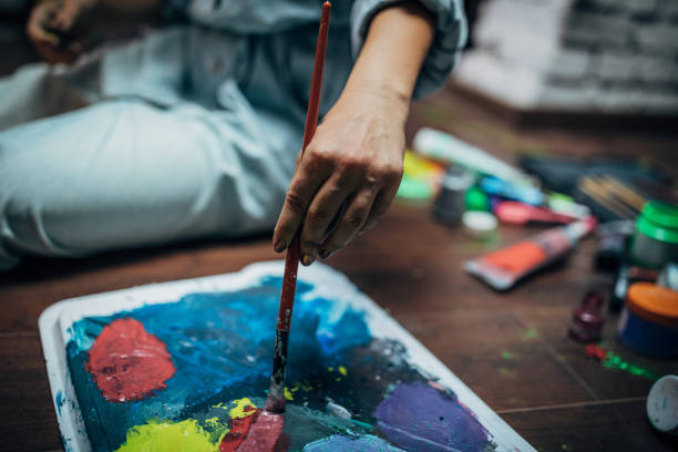 istock Lady painter painting on the floor 1167965492