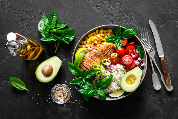 istock Grilled chicken breast lunch bowl with fresh tomato, avocado, corn, red onion, rice and basil 1167965689