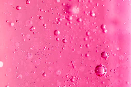 Macro Oxygen bubbles in water on a pink background, concept such as ecology and other uplifting successful projects