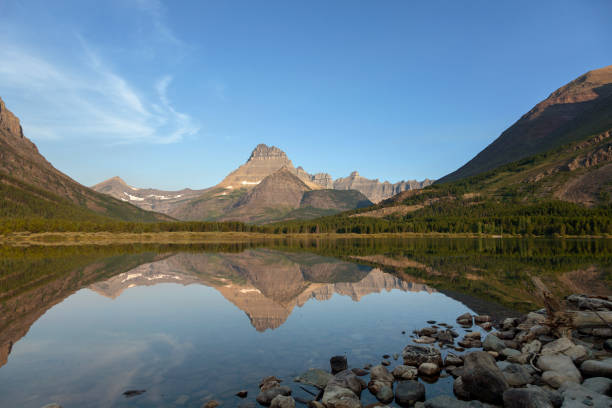 istock Very still lake water with mountain reflections 1167968221