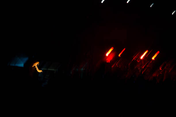 Fire eater burred night shot Motion blurred night shot showing a fire eater juggler's torches. Background is dark and blurred, only fire is clearly visible. burred stock pictures, royalty-free photos & images
