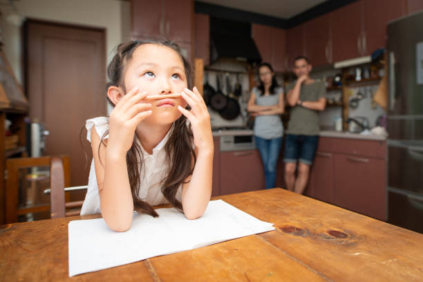 studying girl, mother and father watching from behind - homework pencil people indoors imagens e fotografias de stock