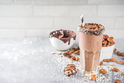 Vegan almond & coconut chocolate smoothie, grey background copy space