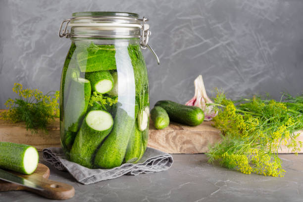 istock Fermentation cucumber in glass jar with garlic and dill on grey table. 1167969477