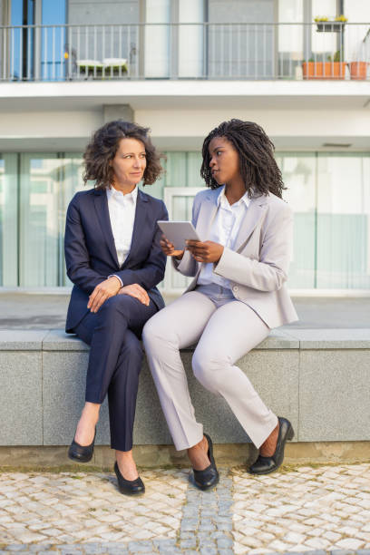 istock Professional female coworkers with tablet pc 1167969519