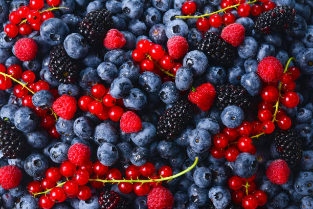 istock Blackberry, raspberry, blueberry,  red currant and mint background. 1167970060