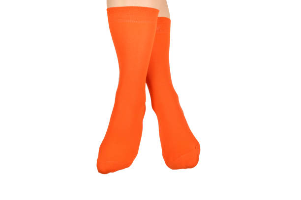 istock Orange socks on woman foot isolated on white background. 1167970086
