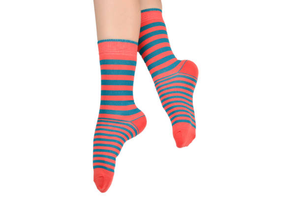 istock Woman in orange socks isolated on white background. Top view. 1167970098