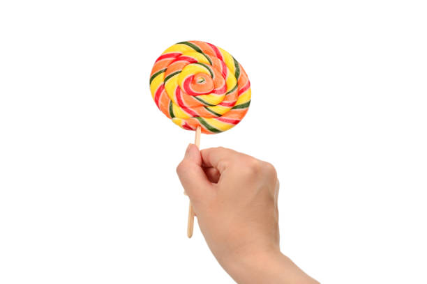 istock Lollipop in female hand isolated on white  background. Space for text or design. 1167970114