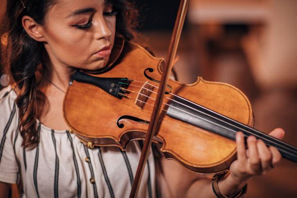 istock Violinist Woman Practicing At Home 1167970871