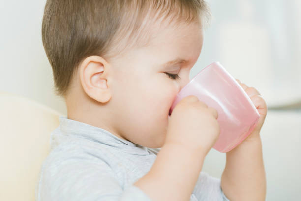 istock child in the kitchen drinking from a cup of water 1167971668