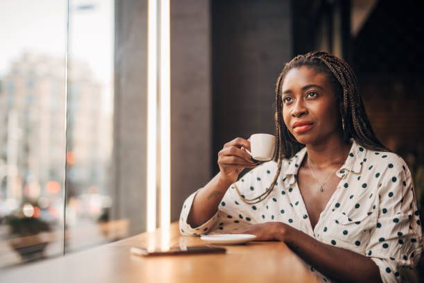 istock Young woman drinking coffee at the cafe 1167972038