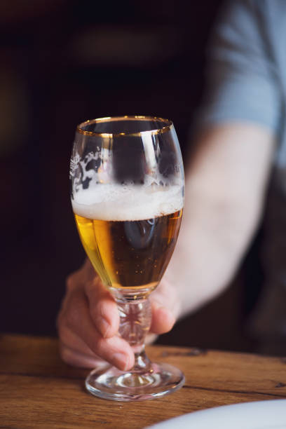 istock Person holding a beer closeup 1167977237