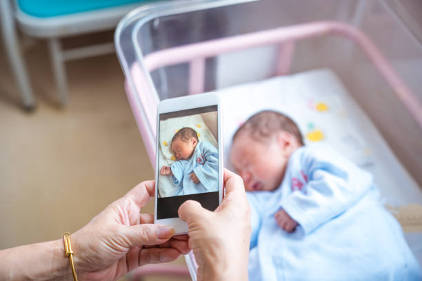 istock Mother photographing newborn son 1167977552