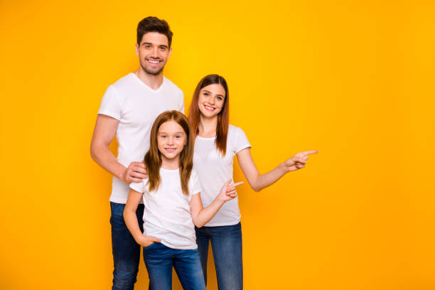 daddy mommy and small lady indicating arms empty space on sale wear casual outfit isolated yellow background - child women outdoors mother imagens e fotografias de stock