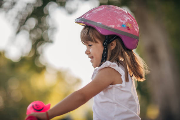 istock Girl learning to drive a bicycle in public park 1167981427