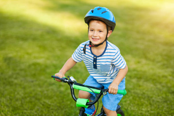 istock Happy 3 year old boy having fun riding a bike 1167982647