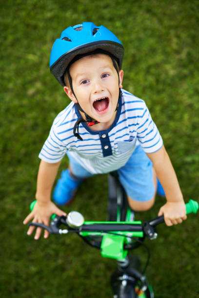 istock Happy 3 year old boy having fun riding a bike 1167983303