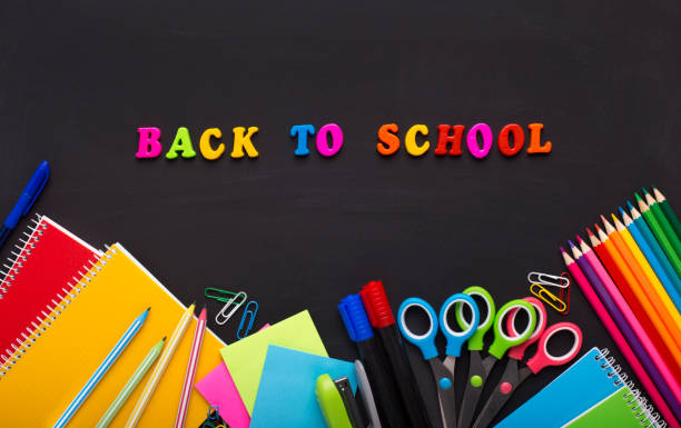 istock Colored Back to school text with stationery on chalk board 1167983369