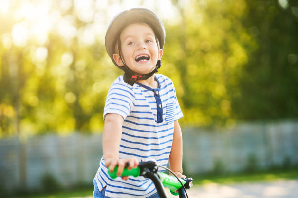 istock Happy 3 year old boy having fun riding a bike 1167983741