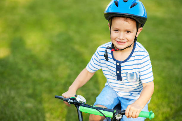 istock Happy 3 year old boy having fun riding a bike 1167983946