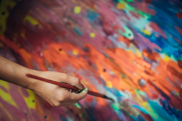 istock Creative woman painting in her studio 1167985830