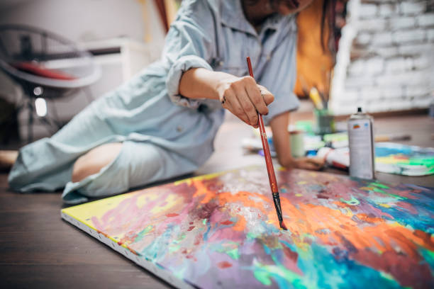istock Creative woman painting in her studio 1167985893